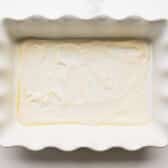 A thin layer of Alfredo on the bottom of a baking dish.