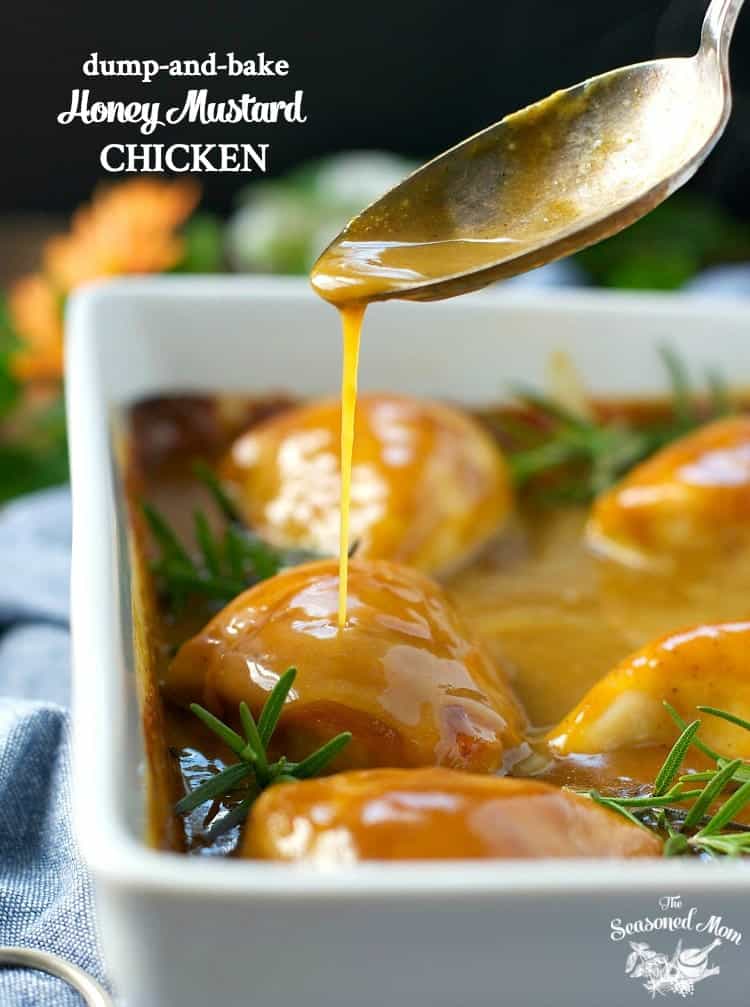 A close up of honey mustard chicken in a dish with a spoon pouring over some sauce