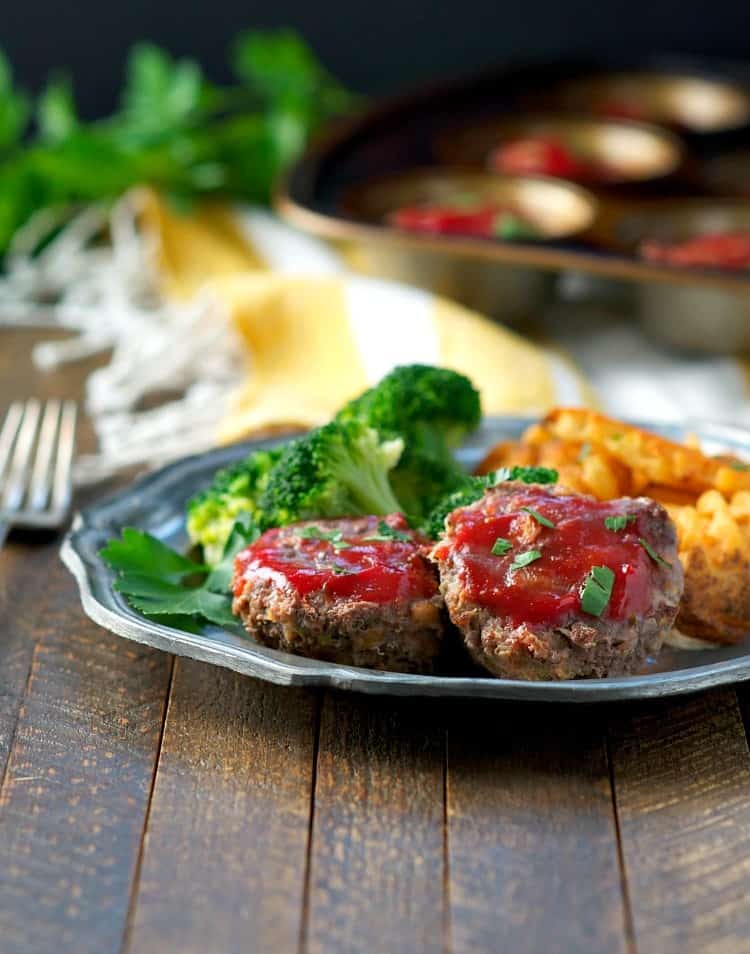 Mini meatloaf on a plate with broccoli and fries