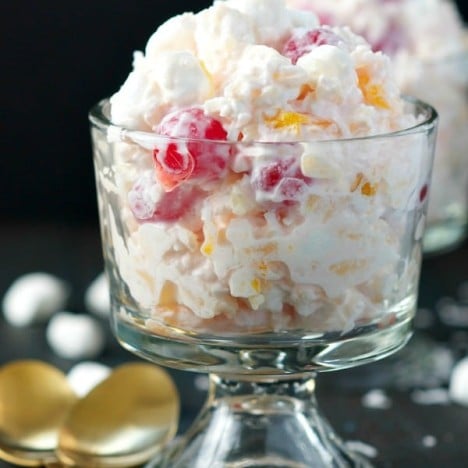 Front shot of ambrosia salad recipe in a glass serving dish
