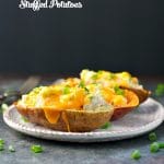 Stuffed potatoes on a plate topped with green onions