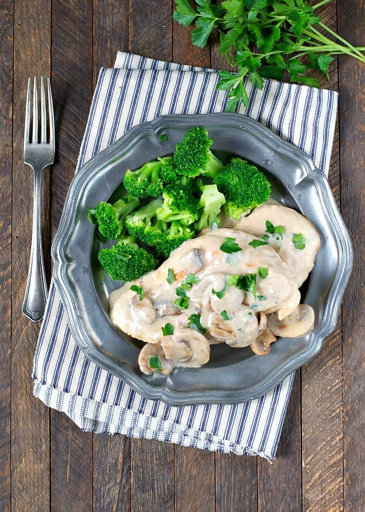 Garlic chicken with mushroom sauce on a plate with a side of broccoli