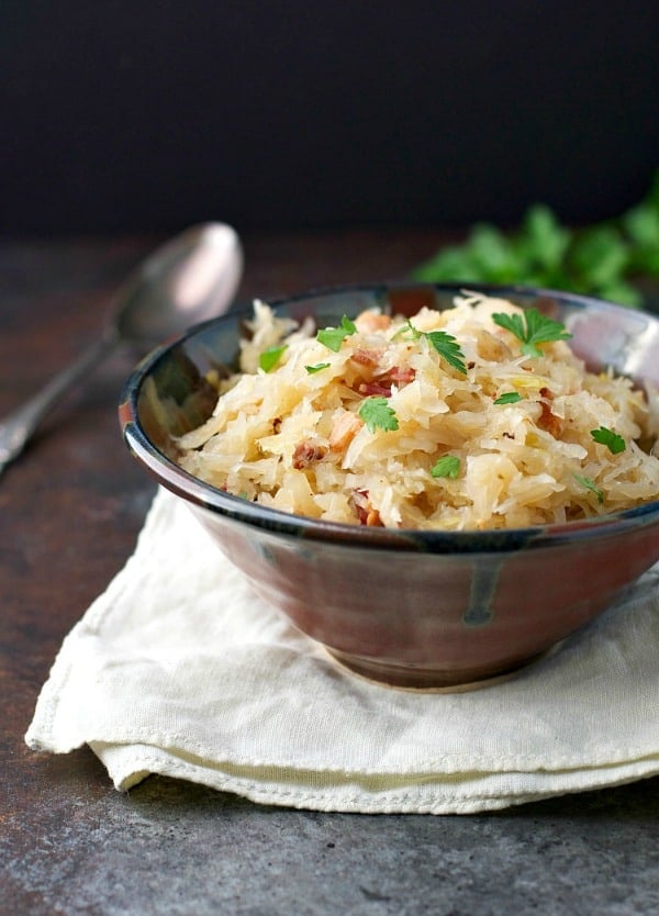 Partial front shot of a bowl of sauerkraut with parsley on top