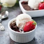 Bowl of Strawberry Chocolate Dump Cake topped with vanilla ice cream