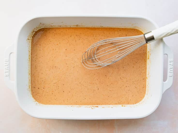 Whisking the sauce in the baking dish.