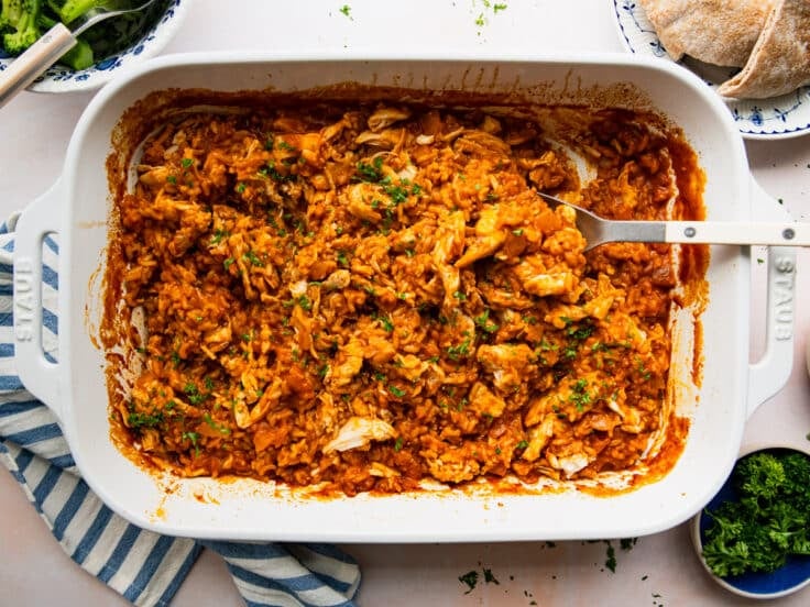 Horizontal overhead image of a butter chicken casserole in a white dish.