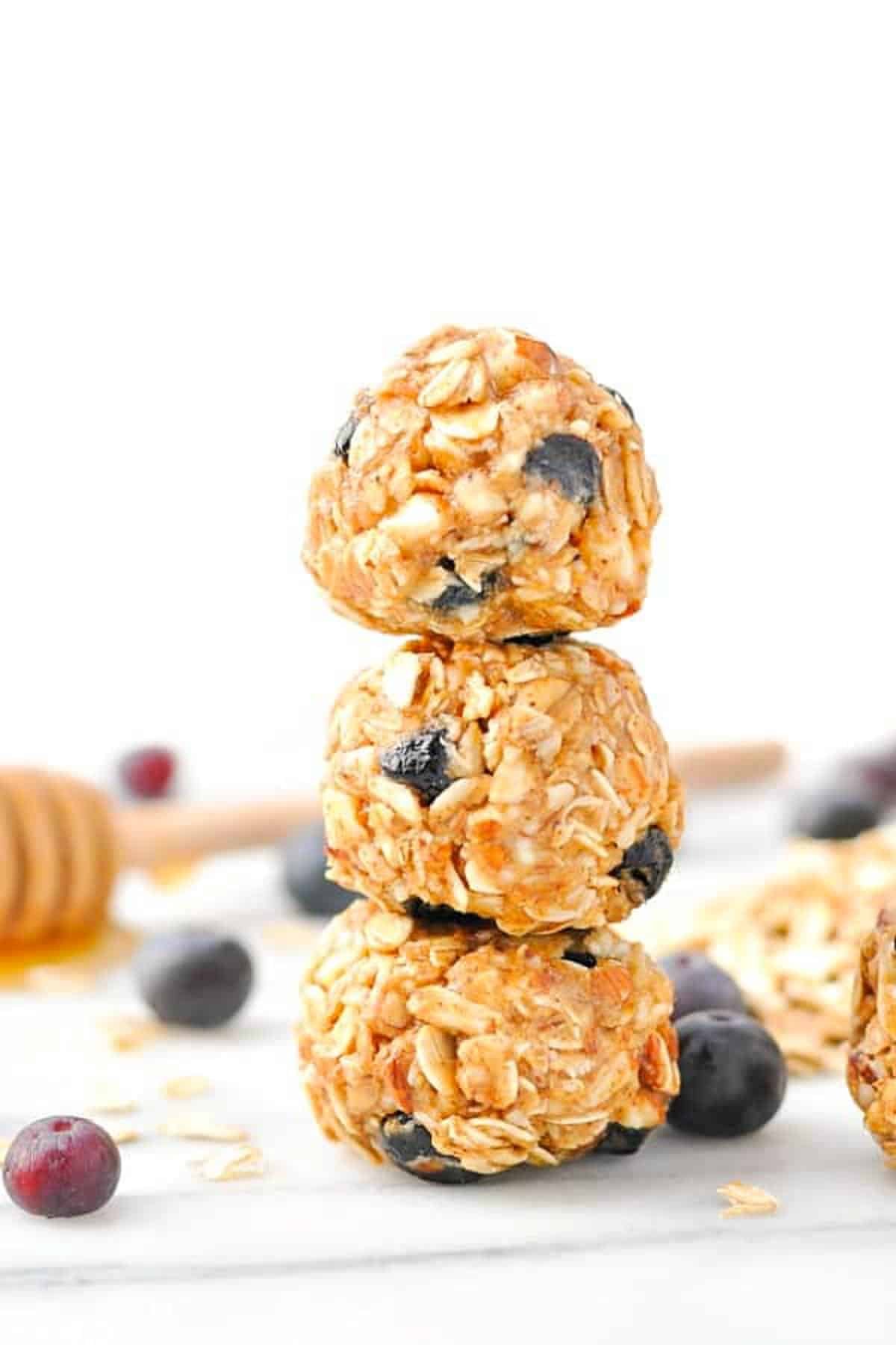 Three almond blueberry energy snacks stacked on top of each other.