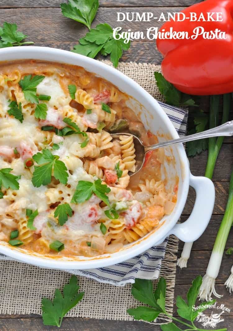 A close up of Cajun chicken pasta in a white dish with a spoon