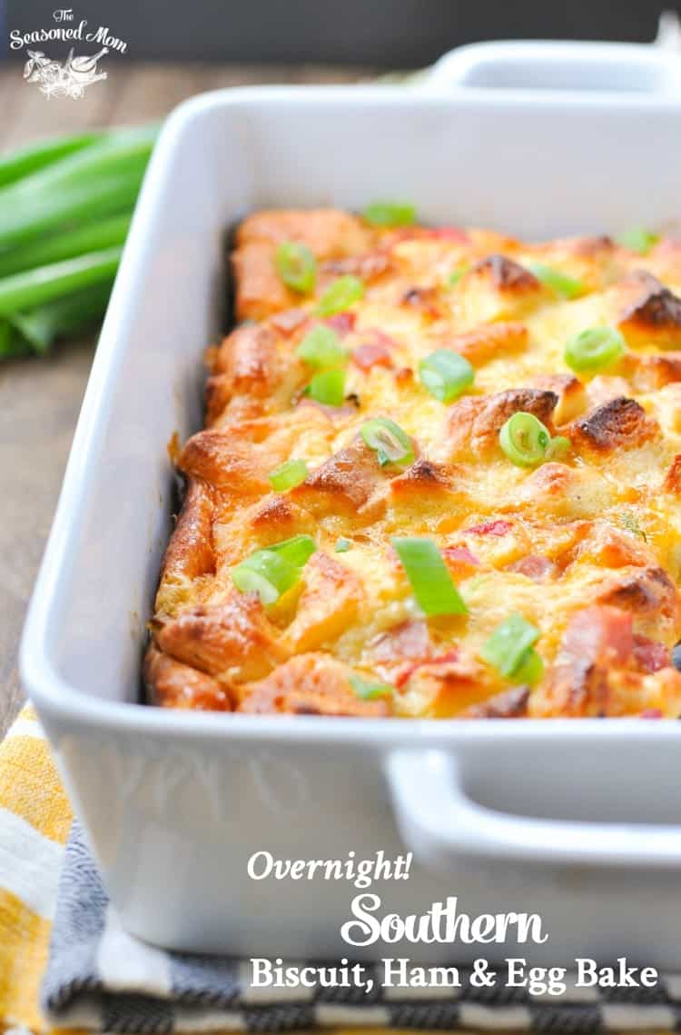 A close up image of an overnight egg bake in a casserole dish and topped with green onions