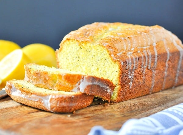 Horizontal shot of glazed lemon bread loaf on a cutting board