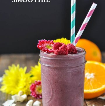 A southern ambrosia smoothie in a mason jar and topped with fruit