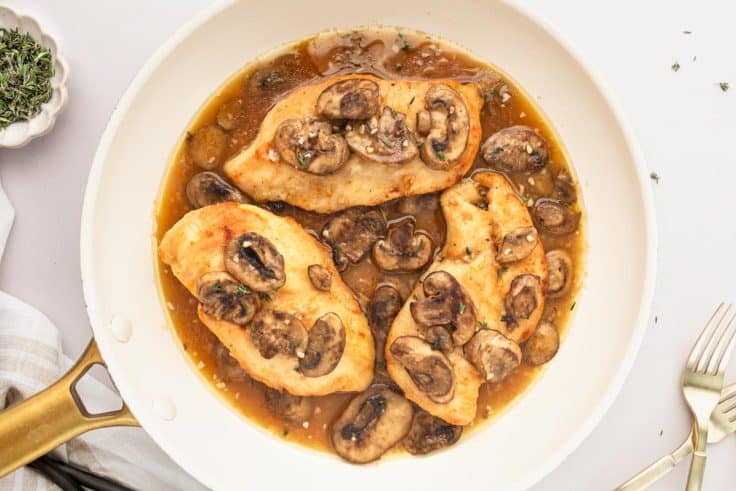 Process shot showing how to make quick and easy chicken marsala in a skillet.