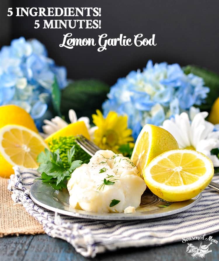 Lemon garlic cod on a plate with slices of lemon