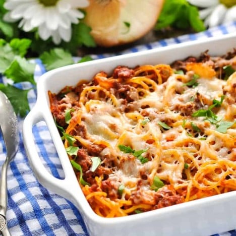 A side shot of baked spaghetti in a casserole dish