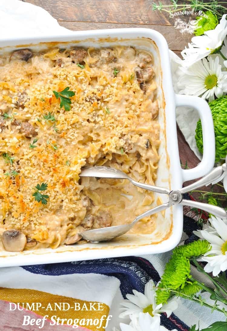 An overhead shot of a beef stroganoff casserole with serving spoons