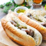 A close up of beer brats in buns
