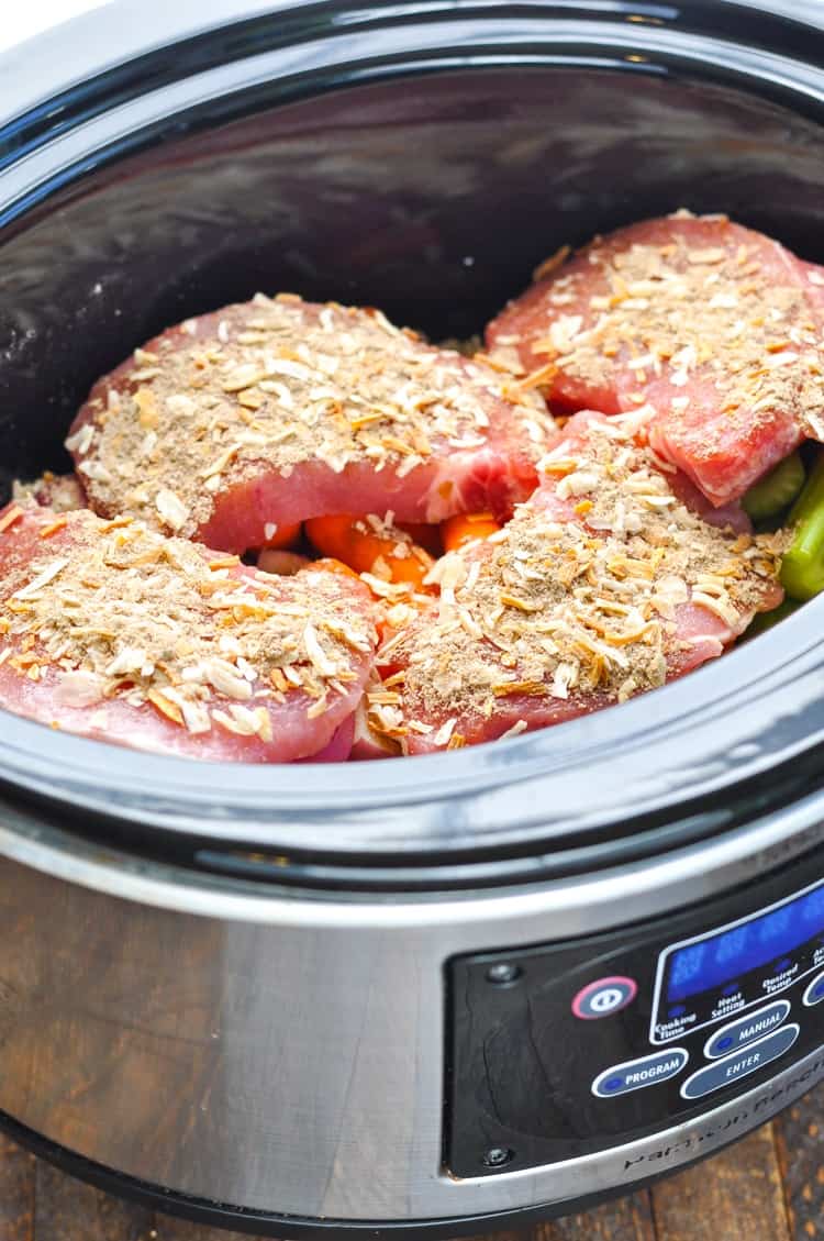 Slow cooker pork chops in a slow cooker with vegetables