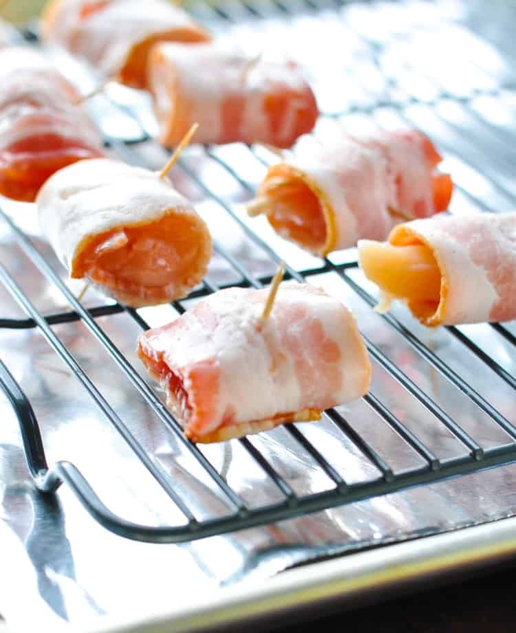 Bacon wrapped chicken bites sitting on a baking sheet ready to be baked