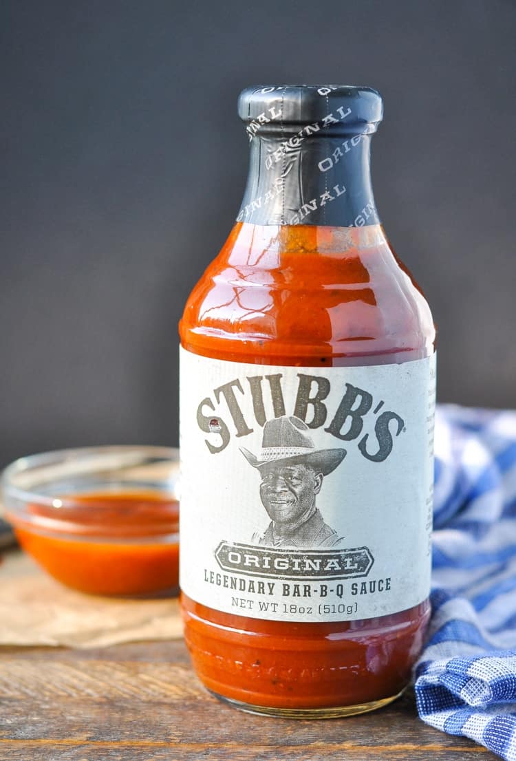 A bottle of Stubb's bbq sauce sitting on a wooden surface