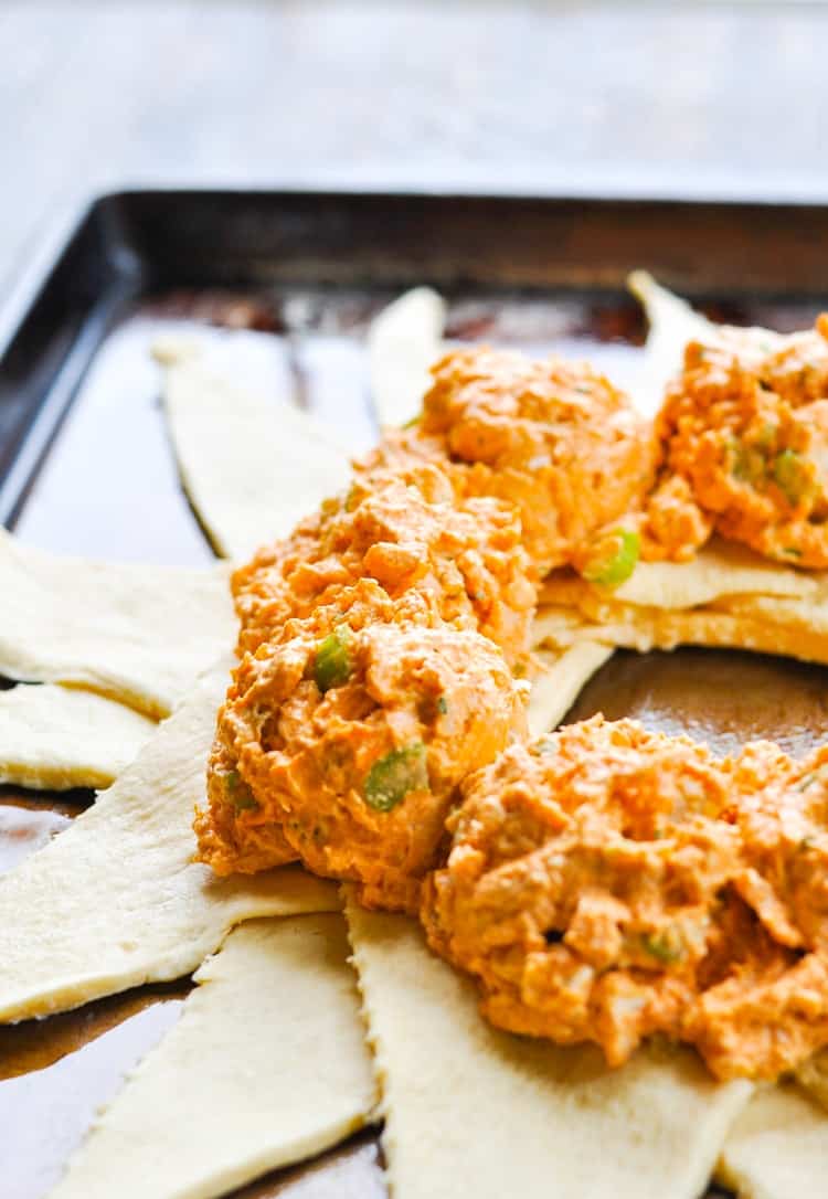 A side shot of buffalo chicken dip on a pastry ring