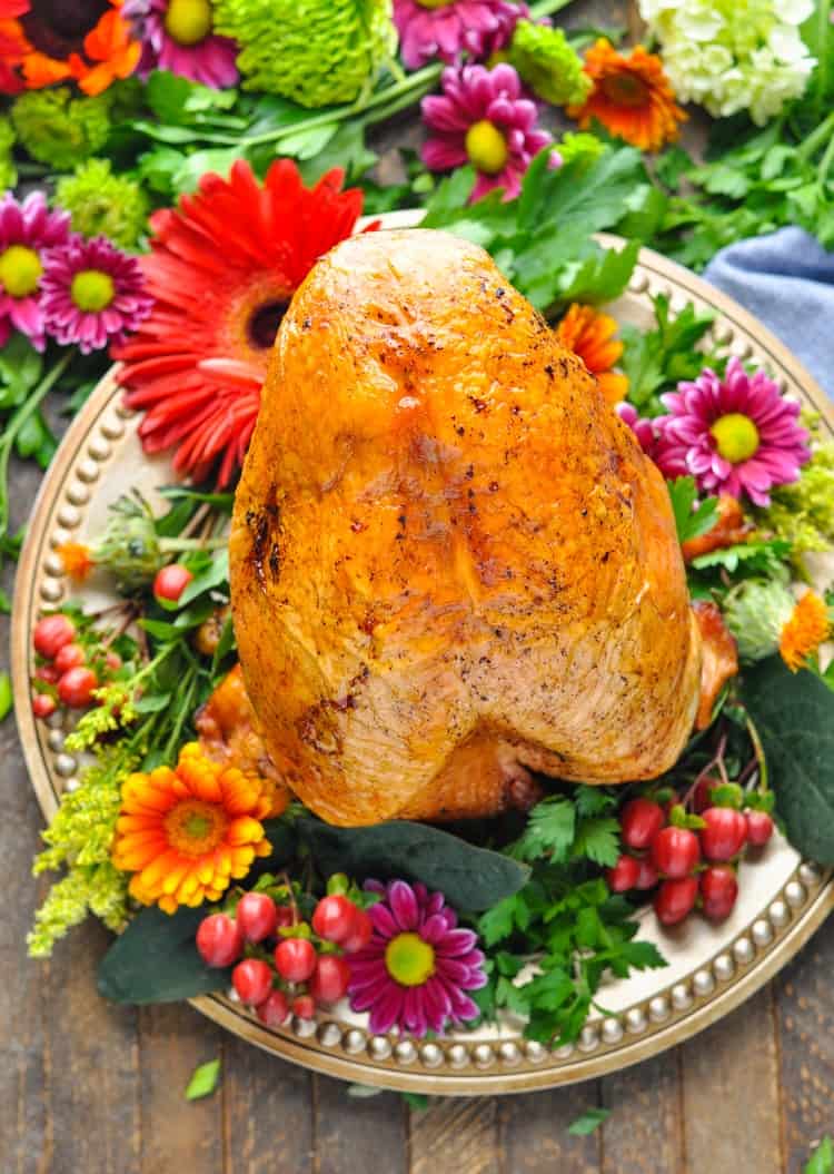 An overhead shot of a roast turkey breast on a serving plate