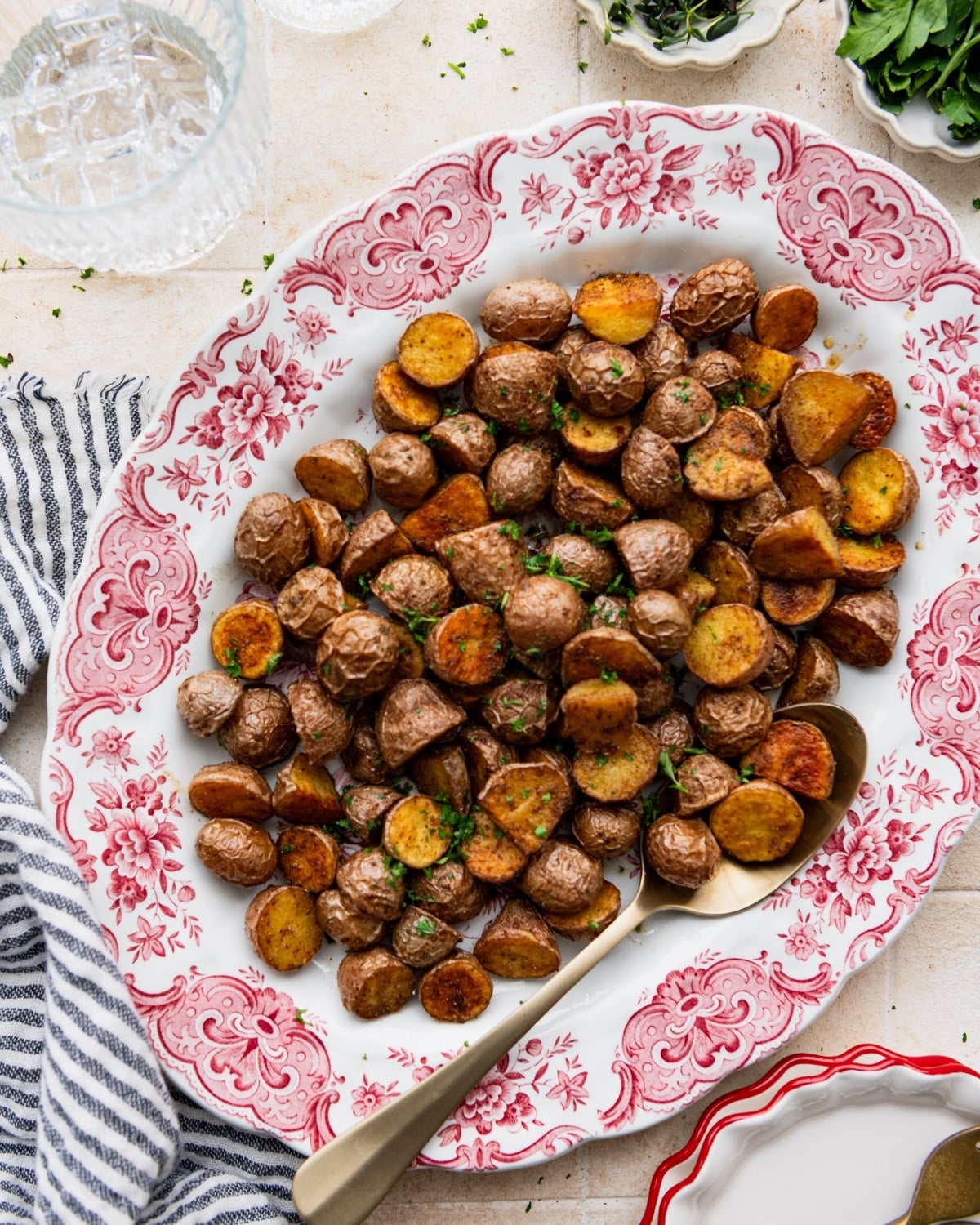 Overhead shot of a platter of crispy seasoned potatoes.