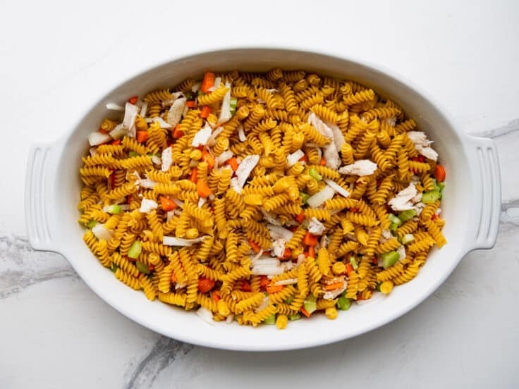 Ingredients in a baking dish for a chicken noodle casserole.