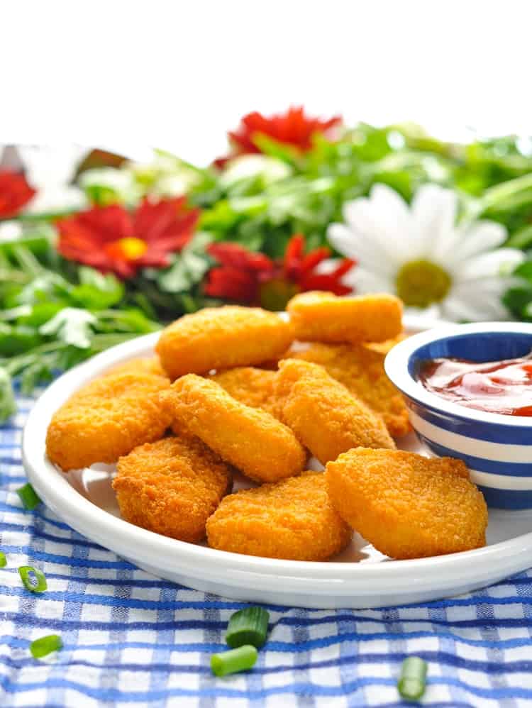 Chicken nuggets on a plate with ketchup for making a tater tot casserole