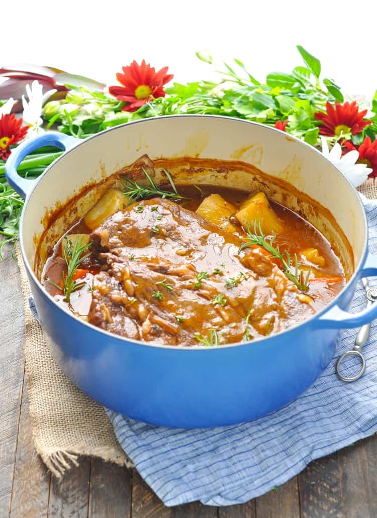 A large blue pot filled with a classic pot roast