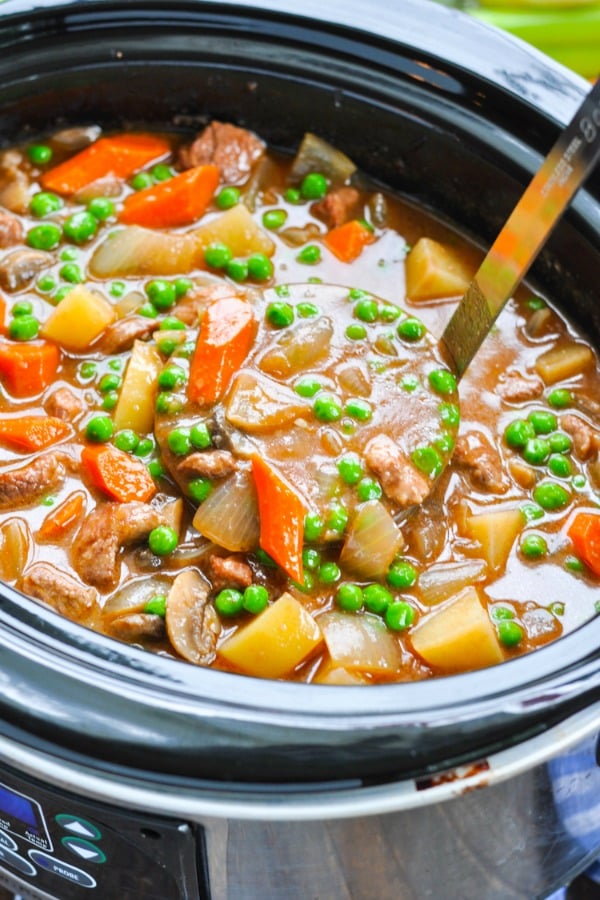 Easy beef stew with potatoes and carrots and peas in a slow cooker