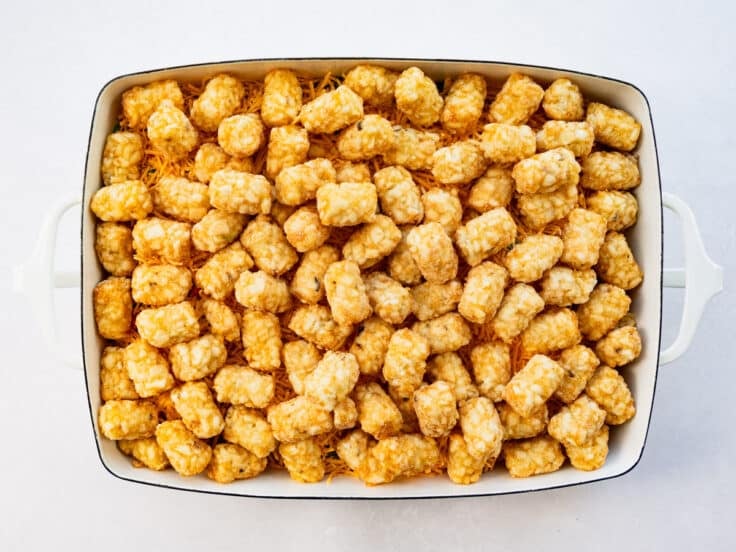 Tater tots spread on top before baking.