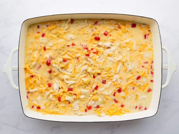 Adding the pasta, cheese, chicken and remaining ingredients to the pan.