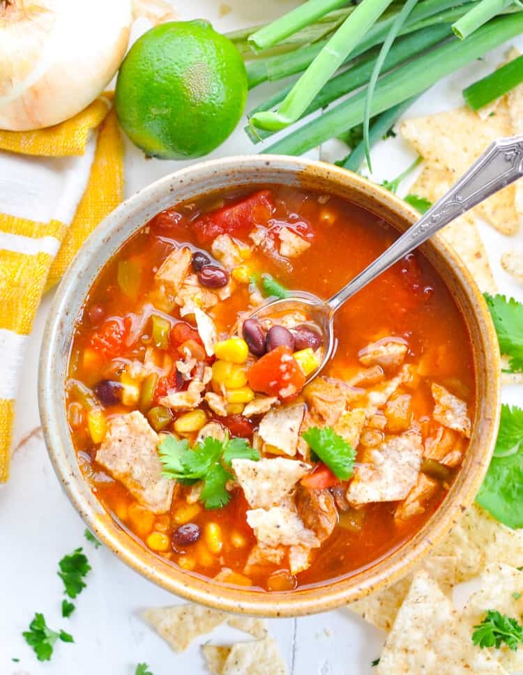 easy chicken tortilla soup in a bowl with a spoon