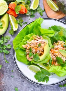 Close overhead photo of Asian Turkey Lettuce Wraps on a plate with garnishes at the side