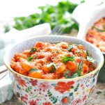 Close up shot of chicken marinara gnocchi recipe in a colorful bowl with fresh parsley on top