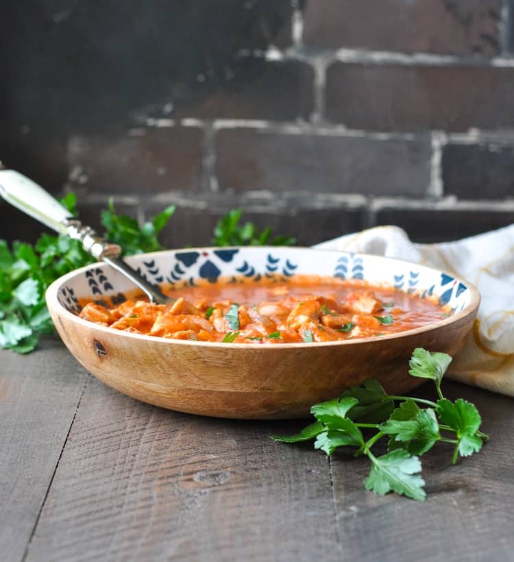 Large bowl with serving spoon of healthy Chicken Tikka Masala dinner