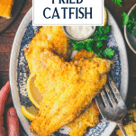 Hands serving catfish from a platter with text title overlay