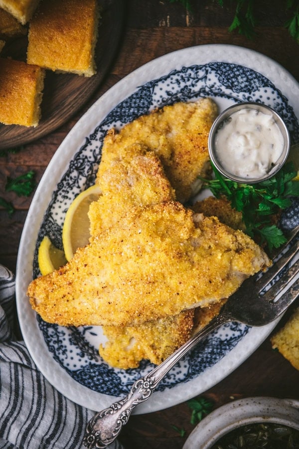 Close overhead shot of a plate of crispy Southern fried catfish.