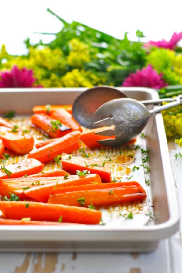Brown Sugar Roasted Carrots on a baking sheet garnished with parsley