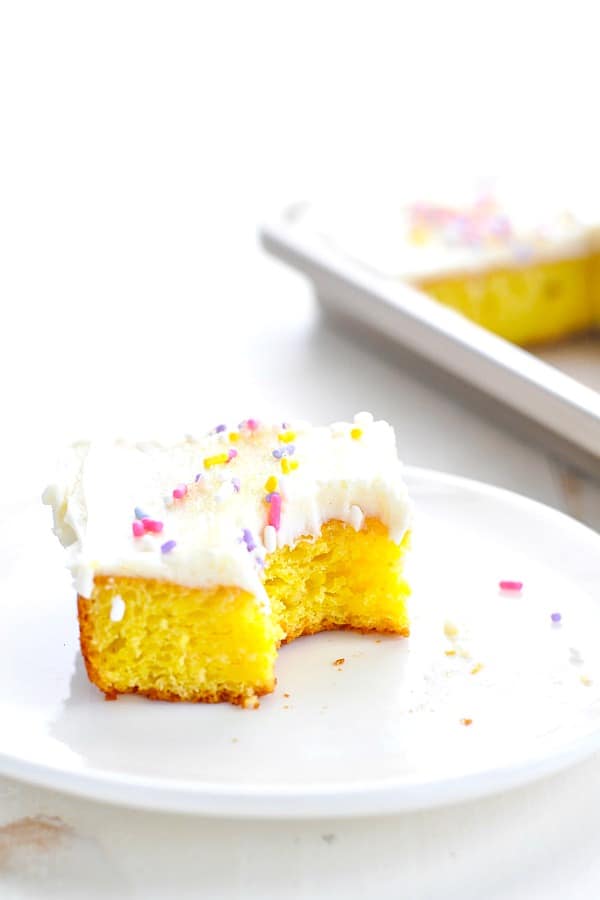 Frosted lemon bar with a bite taken out of it