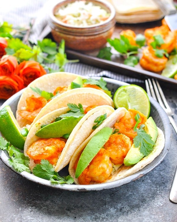 Front shot of three shrimp tacos on a plate