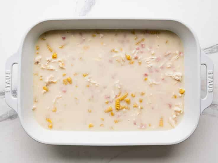 Ingredients stirred together in the white baking dish.