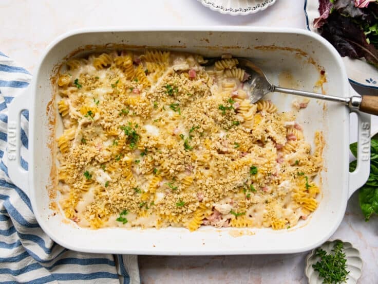 Horizontal overhead shot of a chicken cordon bleu casserole in a white baking dish.