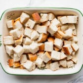 Bread cubes arranged in a baking dish.