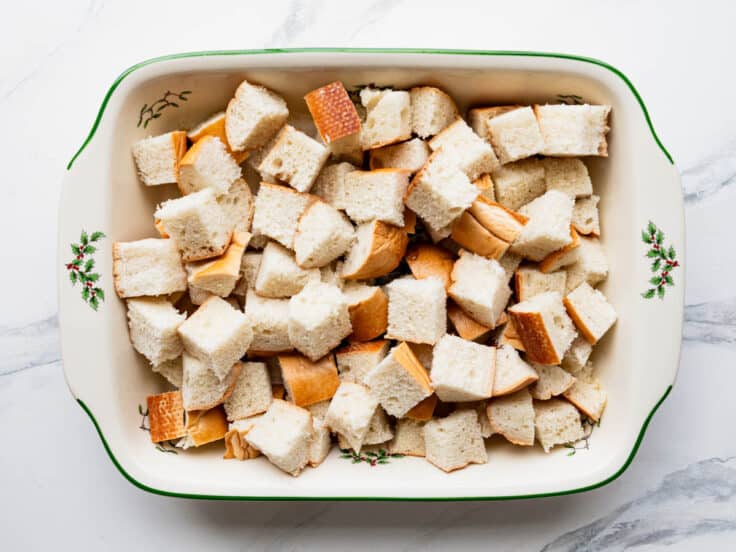 Bread cubes arranged in a baking dish.
