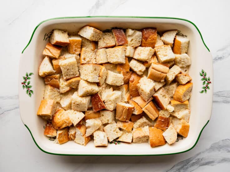 Adding the custard to bread cubes.