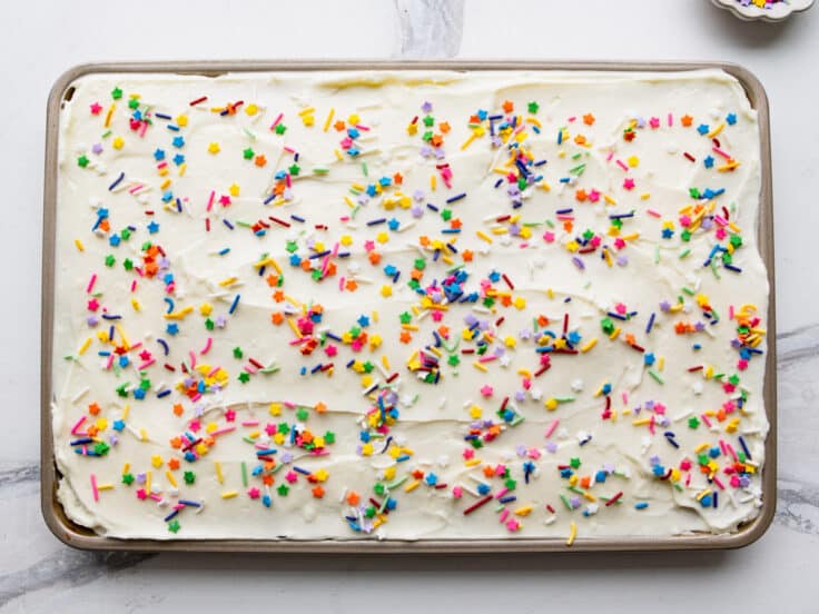 Frosting and sprinkles spread on lemon bars with cake mix.