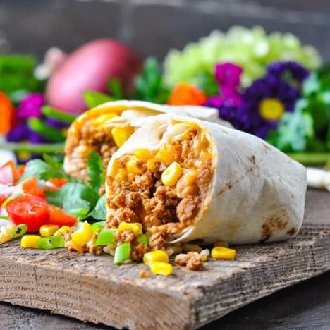 Square side shot of the easiest burrito recipe on a wooden board
