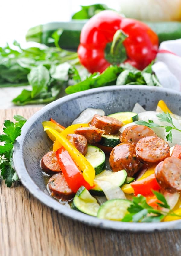 Bowl of Italian Sausage and Peppers with other fresh vegetables cooked in a foil pack.