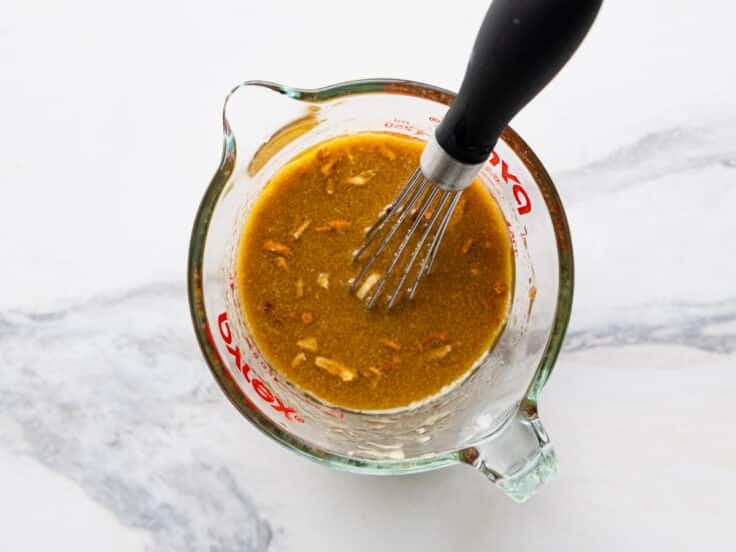 Whisking together the sauce.